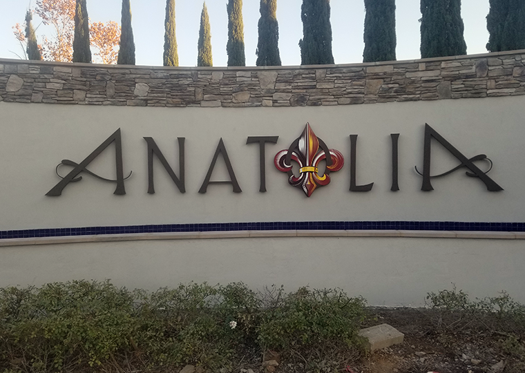 Elegant monument entrance sign for Anatolia community featuring dimensional letters and decorative emblem by Sign Masters, Northern California architectural signage specialists.