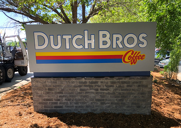 Custom monument sign for Dutch Bros Coffee with dimensional lettering fabricated and installed by Sign Masters, Sacramento business signage experts.